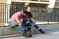 Couple on rollerblades is sitting. Royalty Free Stock Photo