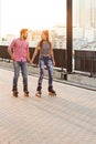 Couple rollerblading and holding hands. Royalty Free Stock Photo