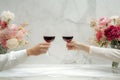 Couple on romantic date. Friends clinking glasses, top view. Red wine, flowers around on wooden table. Wedding celebration, party Royalty Free Stock Photo