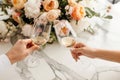 Couple on romantic date. Friends clinking glasses, top view. White wine, flowers around on marble table. Wedding celebration, Royalty Free Stock Photo