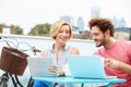 Couple On Roof Terrace Using Laptop And Digital Tablet Royalty Free Stock Photo