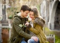 Couple with rose in love kissing on street alley celebrating Valentines day with passion sitting on city park Royalty Free Stock Photo