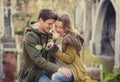 Couple with rose in love kissing on street alley celebrating Valentines day with passion sitting on city park Royalty Free Stock Photo