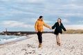 couple running along autumn beach Royalty Free Stock Photo