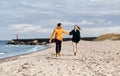 couple running along autumn beach Royalty Free Stock Photo