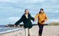 couple running along autumn beach Royalty Free Stock Photo