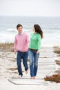 Couple running along beach path holding hands Royalty Free Stock Photo