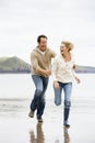 Couple running on beach Royalty Free Stock Photo