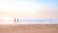 Couple running on the beach. Happy couple go to swim in ocean at sunset. Blurred summer vacation background. Defocused man and Royalty Free Stock Photo