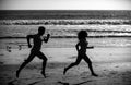 Couple running on beach. Sport and healthy lifestyle, silhouette friends jogging at sunset on the beach.