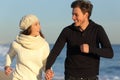 Couple running on the beach in winter Royalty Free Stock Photo