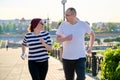 Couple running in city, mature man and woman together