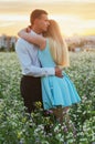 Couple running in field holding hands. Royalty Free Stock Photo