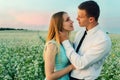 Couple running in field holding hands. Royalty Free Stock Photo