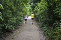 Couple running on trail at `Bosque da Freguesia` Public park in the neighborhood of Jacarepagua Royalty Free Stock Photo