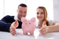 Couple`s Hand Protecting Piggybank