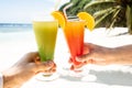 Couple`s Hand Toasting The Glasses Of Cocktail At Beach