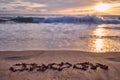 Couple`s initials and a heart shape carved on the sands of a beach at Maui, Hawaii during sunset Royalty Free Stock Photo