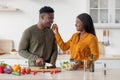 Couple's Lifestyle. Romantic Black Man And Woman Cooking Food In Kitchen Together Royalty Free Stock Photo
