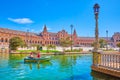 The couple sails along the canal in Plaza de Espana in Seville, Spain Royalty Free Stock Photo