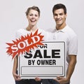 Couple with For Sale by Owner Sign Royalty Free Stock Photo