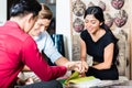 Couple with salesman in furniture store Royalty Free Stock Photo