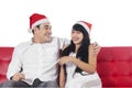 Couple in santa hat laughing together Royalty Free Stock Photo