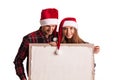 Couple in Santa hats with banner Royalty Free Stock Photo