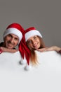 Couple in Santa hats with banner Royalty Free Stock Photo