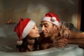 Couple in santa hats is enjoying a bath Royalty Free Stock Photo