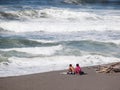 Couple on beach in Oregan watching the waves Royalty Free Stock Photo