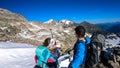 Couple with scenic view on Hoher Sonnblick in High Tauern mountains in Carinthia, Salzburg, Austria, Europe, Alps. Woman is