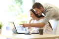 Couple searching online in a laptop at home Royalty Free Stock Photo