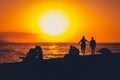 couple at seaside dating, watching sunset sky over ocean Royalty Free Stock Photo