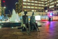 `Couple on seat` talking sculpture by Lynn Chadwick in Cabot Square, Canary Wharf, London.