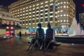 `Couple on seat` talking sculpture by Lynn Chadwick in Cabot Square, Canary Wharf, London.