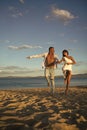 Couple secrets fantasy. Man and woman hold hands, couple happy on vacation. Couple in love stand on beach, seashore