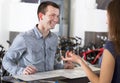 Couple selecting bikes at rental agency