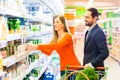 Couple selecting cooled products in hypermarket