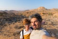 Couple selfie in the desert, Namib Naukluft National Park, Namibia road trip, travel destination in Africa. Royalty Free Stock Photo