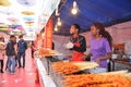 A couple selling grilled lamb kebab on food street