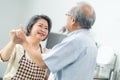 Couple senior Asian elder happy living in home kitchen. Grandfather hug grandmother with happiness and smile enjoy retirement life Royalty Free Stock Photo