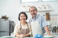 Couple senior Asian elder happy living in home kitchen. Grandfather hug grandmother with happiness and smile enjoy retirement life Royalty Free Stock Photo