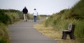 A couple of senior hikers walking away on Westport Light trail