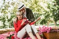 Couple senior man surprise giving gift box to his wife while relaxing in the park Royalty Free Stock Photo