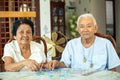 Couple senior playing with a jigsaw puzzle at home Royalty Free Stock Photo