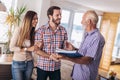 Couple with real-estate agent visiting house for sale