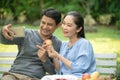 Couple senior using a mobile phone taking a picture together while having a dinner outdoor. Happy retirement people with Royalty Free Stock Photo