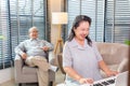 Couple Seniors playing piano and singing songs having fun together happily at home Royalty Free Stock Photo