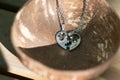Couple set pendant necklace two half of a heart shoot outdoors in a sunny day closeup. Selective focus
